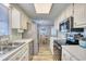 Spacious kitchen with stainless steel appliances and ample counter space, flowing into the dining area at 121 Easy St., Garden City Beach, SC 29576