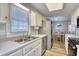 Bright kitchen featuring stainless steel appliances, white cabinetry, and laminate countertops at 121 Easy St., Garden City Beach, SC 29576