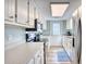 Bright kitchen with white cabinets, stainless steel appliances, and light-colored countertops at 121 Easy St., Garden City Beach, SC 29576