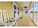 Inviting porch featuring rocking chairs, a table, and stylish decor at 121 Easy St., Garden City Beach, SC 29576