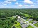 Beautiful aerial view of a home surrounded by lush greenery and a serene pond in a quiet neighborhood at 124 Castaway Key Dr., Pawleys Island, SC 29585