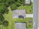 Aerial view of home showing the solar panels, driveway, backyard, and surrounding greenery at 124 Castaway Key Dr., Pawleys Island, SC 29585