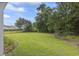 Large, flat backyard with lush green grass and a black metal fence at 124 Castaway Key Dr., Pawleys Island, SC 29585