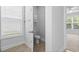 Bright bathroom features tile floors, toilet, and a window with blinds at 124 Castaway Key Dr., Pawleys Island, SC 29585