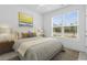 Bright bedroom featuring a ceiling fan and a view of the outdoors through a large window at 124 Castaway Key Dr., Pawleys Island, SC 29585