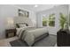 Stylishly furnished bedroom with a comfortable bed, large window, and elegant decor at 124 Castaway Key Dr., Pawleys Island, SC 29585