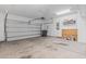 Spacious garage with large door, concrete floor, and storage shelves at 124 Castaway Key Dr., Pawleys Island, SC 29585