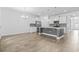 Open-concept kitchen with stainless steel appliances, granite countertops, island, and ceramic tile flooring at 124 Castaway Key Dr., Pawleys Island, SC 29585