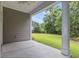 Covered patio overlooking the large grassy backyard with a black metal fence at 124 Castaway Key Dr., Pawleys Island, SC 29585