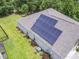 Aerial view showcasing solar panels on a home's roof, surrounded by lush greenery and landscaping at 124 Castaway Key Dr., Pawleys Island, SC 29585