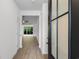 Bright foyer featuring a modern front door and an open view to the living area with hardwood floors at 124 Shady Arbor Loop, Longs, SC 29568