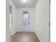 Bright foyer with modern, light-colored wood-look flooring that complements the neutral paint palette at 124 Shady Arbor Loop, Longs, SC 29568