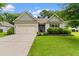 Charming single-story home featuring a well-maintained lawn, attached garage, and lovely curb appeal at 124 Shady Arbor Loop, Longs, SC 29568