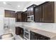 Well-equipped kitchen featuring stainless steel appliances, granite countertops, and dark cabinetry at 124 Shady Arbor Loop, Longs, SC 29568