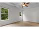 Main bedroom featuring two large windows, a ceiling fan, and tray ceilings at 124 Shady Arbor Loop, Longs, SC 29568
