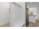 Functional mudroom features a built-in bench with hooks and storage, leading to the kitchen at 124 Shady Arbor Loop, Longs, SC 29568