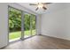 Bright sunroom with sliding glass doors that open to a spacious backyard and lots of natural light at 124 Shady Arbor Loop, Longs, SC 29568