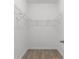 Bright walk-in closet with ventilated shelving and wood-look flooring offers excellent storage at 124 Shady Arbor Loop, Longs, SC 29568
