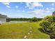 Expansive backyard with stepping stones leading to a serene lake, surrounded by lush green grass at 1304 Marley St., Conway, SC 29527
