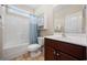 Bathroom with cherry wood cabinets, ceramic tile flooring, bathtub, and toilet at 1304 Marley St., Conway, SC 29527
