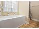 Bright bathtub with a white, sheer curtain, and ceramic tile flooring at 1304 Marley St., Conway, SC 29527