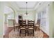 Bright and airy dining room features a modern chandelier and archway access to kitchen at 1304 Marley St., Conway, SC 29527