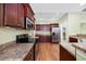 Well-equipped kitchen with stainless steel appliances, granite counters, and wood cabinets at 1304 Marley St., Conway, SC 29527