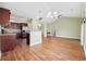 Open-concept living area featuring wood floors and a view to the kitchen with modern light fixtures at 1304 Marley St., Conway, SC 29527