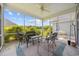 Outdoor screened-in porch with wicker chairs, ceiling fan, and lovely green outdoor view at 1304 Marley St., Conway, SC 29527