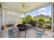Outdoor screened-in porch with wicker chairs, ceiling fan, and beautiful green outdoor view at 1304 Marley St., Conway, SC 29527