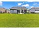 Expansive backyard view showing the screened porch and lush lawn at 136 Crabapple Dr., Longs, SC 29568