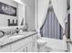 Elegant bathroom featuring granite countertops, white cabinetry, and a shower-tub combination with curtain at 136 Crabapple Dr., Longs, SC 29568