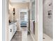 Well-lit bathroom features a double vanity, walk-in shower, and modern fixtures at 136 Crabapple Dr., Longs, SC 29568