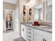 Well-lit bathroom featuring a double granite vanity, white cabinets, and walk-in shower at 136 Crabapple Dr., Longs, SC 29568