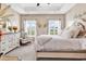 Comfortable bedroom featuring a decorative bedframe, neutral walls, and two bright windows at 136 Crabapple Dr., Longs, SC 29568
