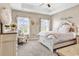 Comfortable bedroom featuring a decorative bedframe, neutral walls, and two bright windows at 136 Crabapple Dr., Longs, SC 29568
