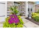 Inviting front porch with stone accents, decorative plants, and a charming front door at 136 Crabapple Dr., Longs, SC 29568