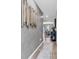 Stylish hallway featuring modern artwork, hardwood floors, and an open view into the dining area at 136 Crabapple Dr., Longs, SC 29568