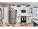 Well-lit kitchen with stainless steel appliances, white cabinets, and granite counters at 136 Crabapple Dr., Longs, SC 29568
