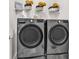 This laundry room features front-load gray washer and dryer with wire shelving and decorations at 136 Crabapple Dr., Longs, SC 29568