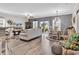 Bright open-concept living room with hardwood floors, sliding glass doors, and stylish decor at 136 Crabapple Dr., Longs, SC 29568