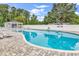 Beautiful community pool surrounded by lush greenery and lounge chairs at 136 Crabapple Dr., Longs, SC 29568