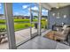 Cozy screened porch featuring charming coastal decor and peaceful waterfront views at 136 Crabapple Dr., Longs, SC 29568