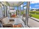 Inviting screened porch with comfortable seating and views of the lush backyard at 136 Crabapple Dr., Longs, SC 29568