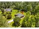 Aerial view of a brick home surrounded by lush greenery at 1478 Bluegil Dr., Longs, SC 29568