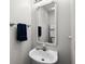 Powder room with a pedestal sink, framed mirror, blue hand towel and neutral paint at 1478 Bluegil Dr., Longs, SC 29568
