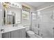 Updated bathroom with large mirror, tiled shower, and neutral color scheme at 1478 Bluegil Dr., Longs, SC 29568