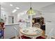 Bright breakfast nook featuring hardwood floors, an elegant light fixture and easy access to the kitchen and living room at 1478 Bluegil Dr., Longs, SC 29568