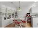 Charming dining area with hardwood floors, decorative light fixture and seating for four people at 1478 Bluegil Dr., Longs, SC 29568