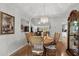 Dining area featuring a round table, chandelier, and hardwood floors at 1478 Bluegil Dr., Longs, SC 29568